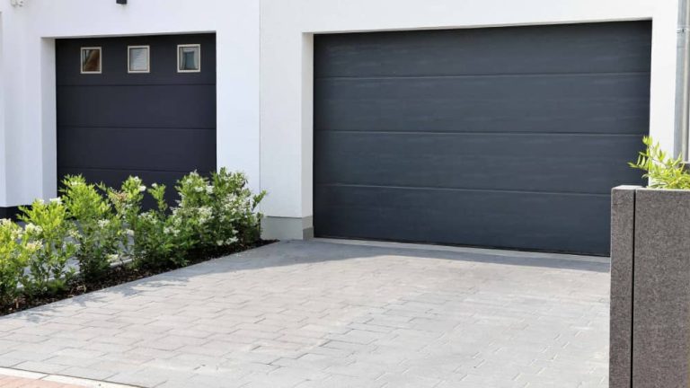 Modern Black Garage Door Design with Brick Driveway